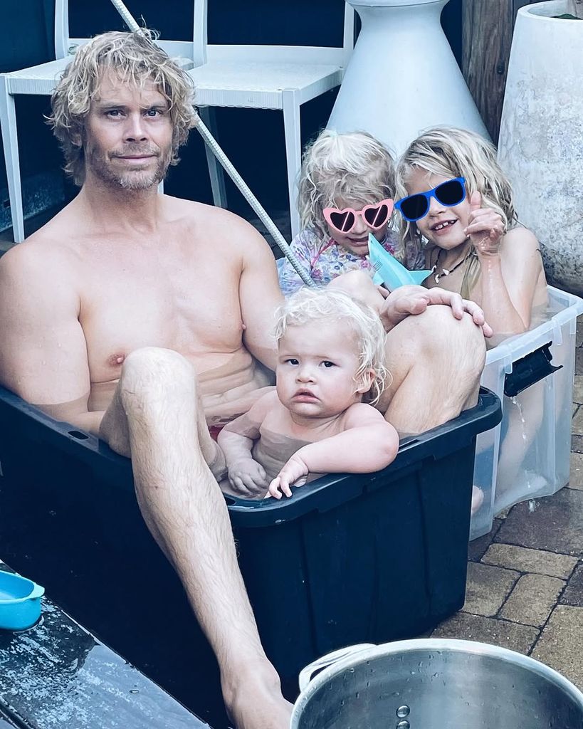 Eric Christian Olsen sits in an ice bucket with three children