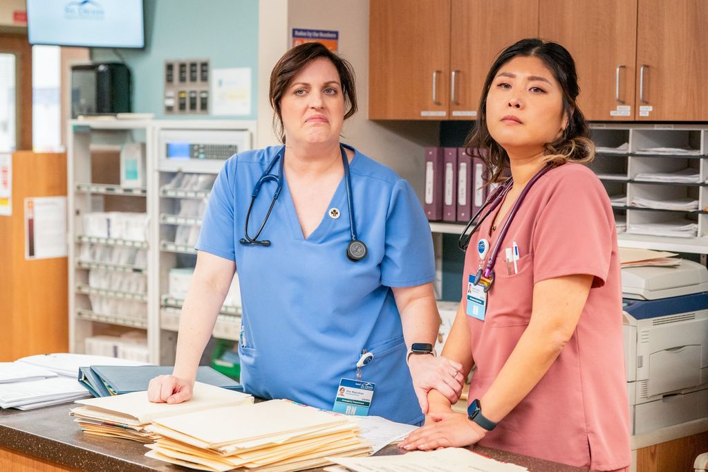 two nurses standing at hospital reception