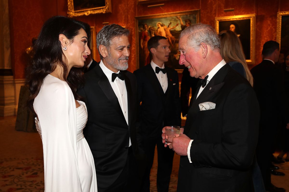 LONDON, ENGLAND - MARCH 12: Amal Clooney and George Clooney speak to Prince Charles, Prince of Wales as they attend a dinner to celebrate The Prince's Trust, hosted by Prince Charles, Prince of Wales at Buckingham Palace on March 12, 2019 in London, England. The Prince of Wales, President, The Princeâs Trust Group hosted a  dinner for donors, supporters and ambassadors of Princeâs Trust International. (Photo by Chris Jackson - WPA Pool/Getty Images)
