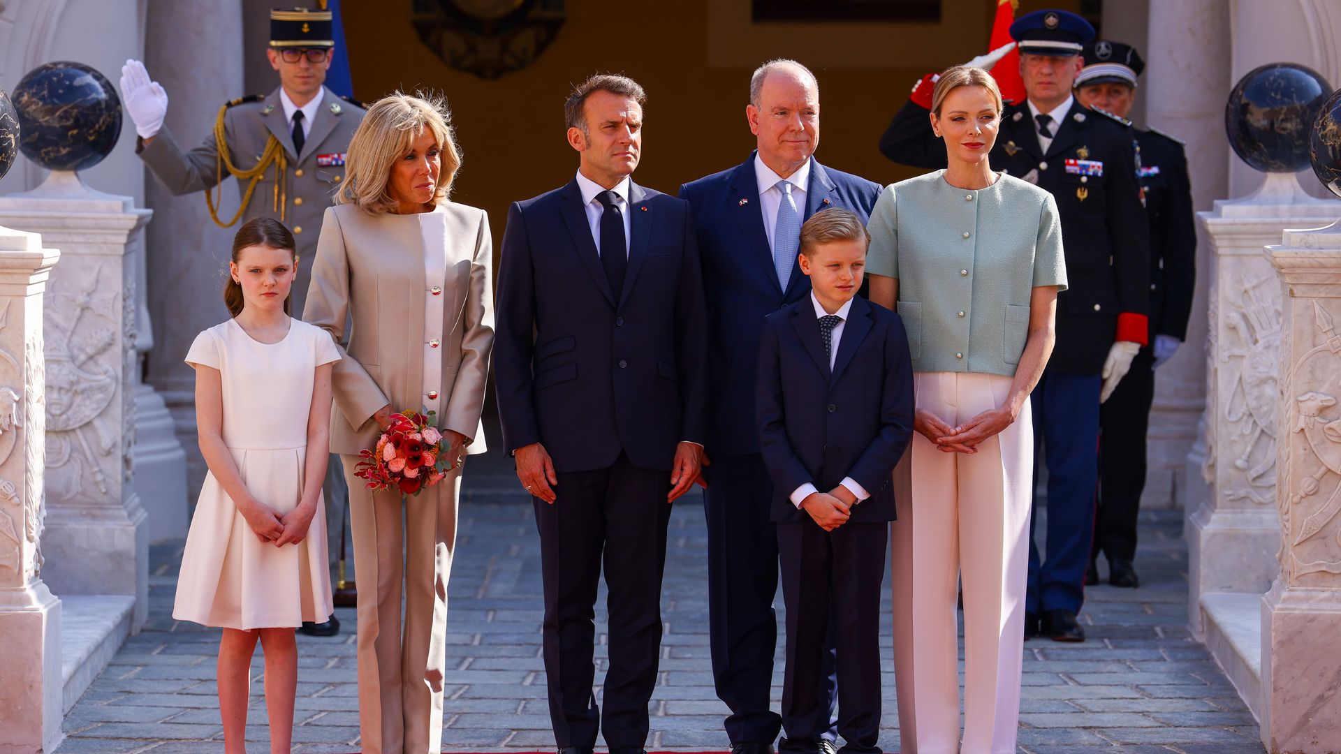 Princess Gabriella standing with Brigitte Macron, Emmanuel Macron, Prince Albert, Prince Jacques and Princess Charlene