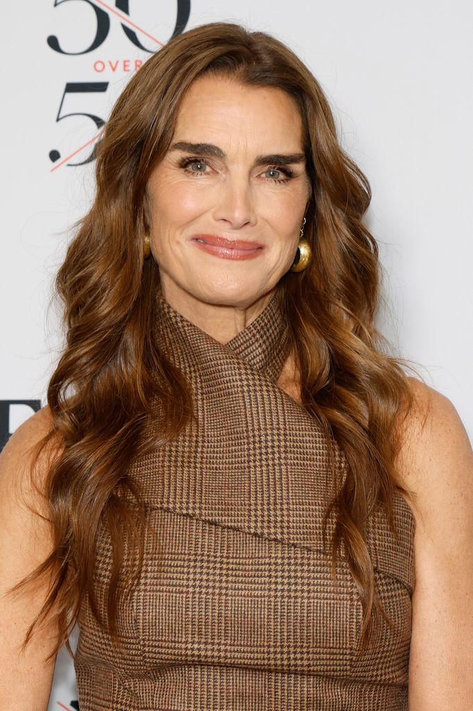 brooke shields looking made up in a tweed top