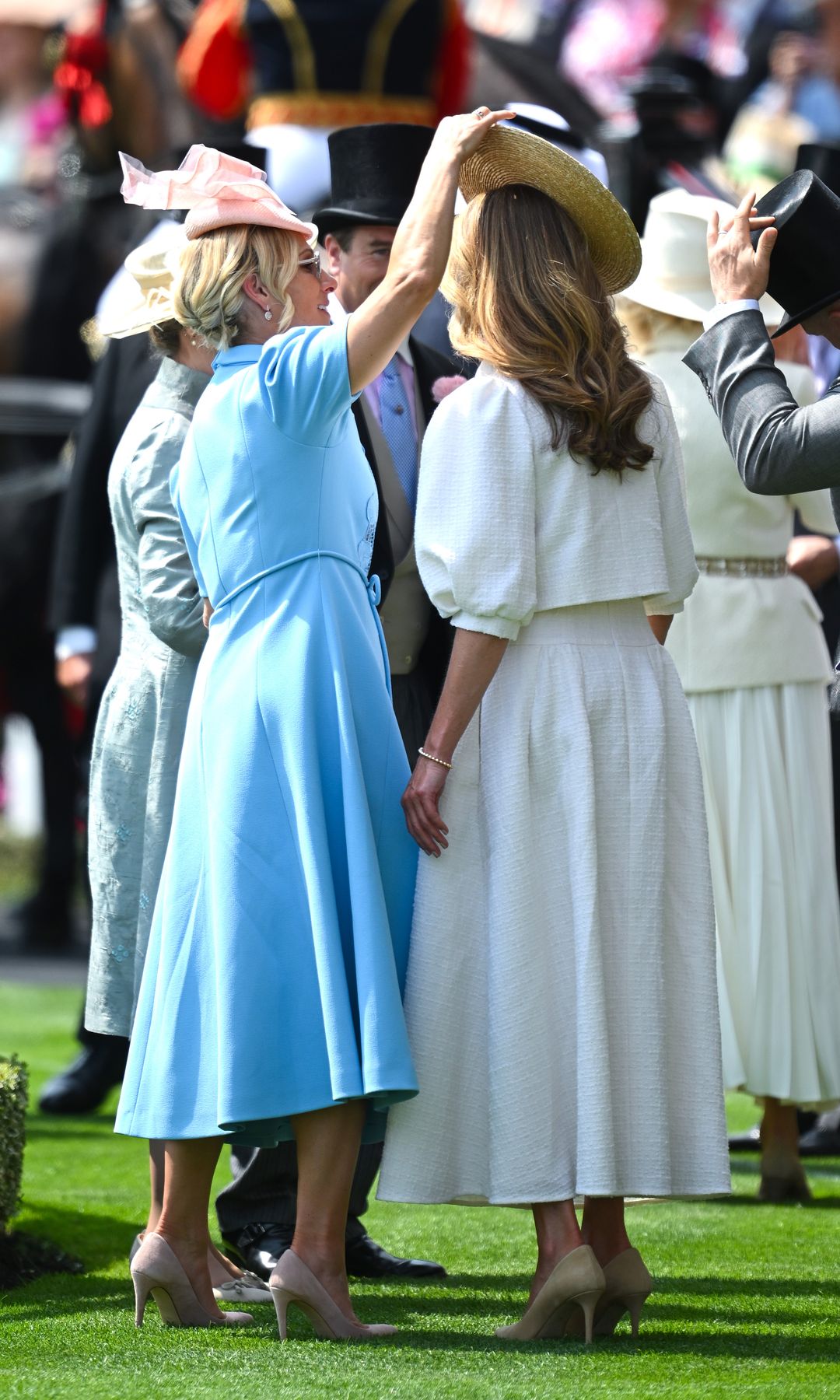 Zara Tindall adjusting Princess Beatrice's hat