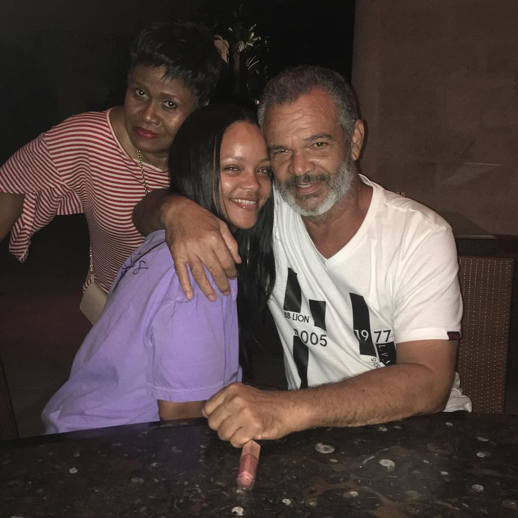 Ronald Fenty and daughter Rihanna pose for a picture in 2018 with Monica Braithwaite behind them