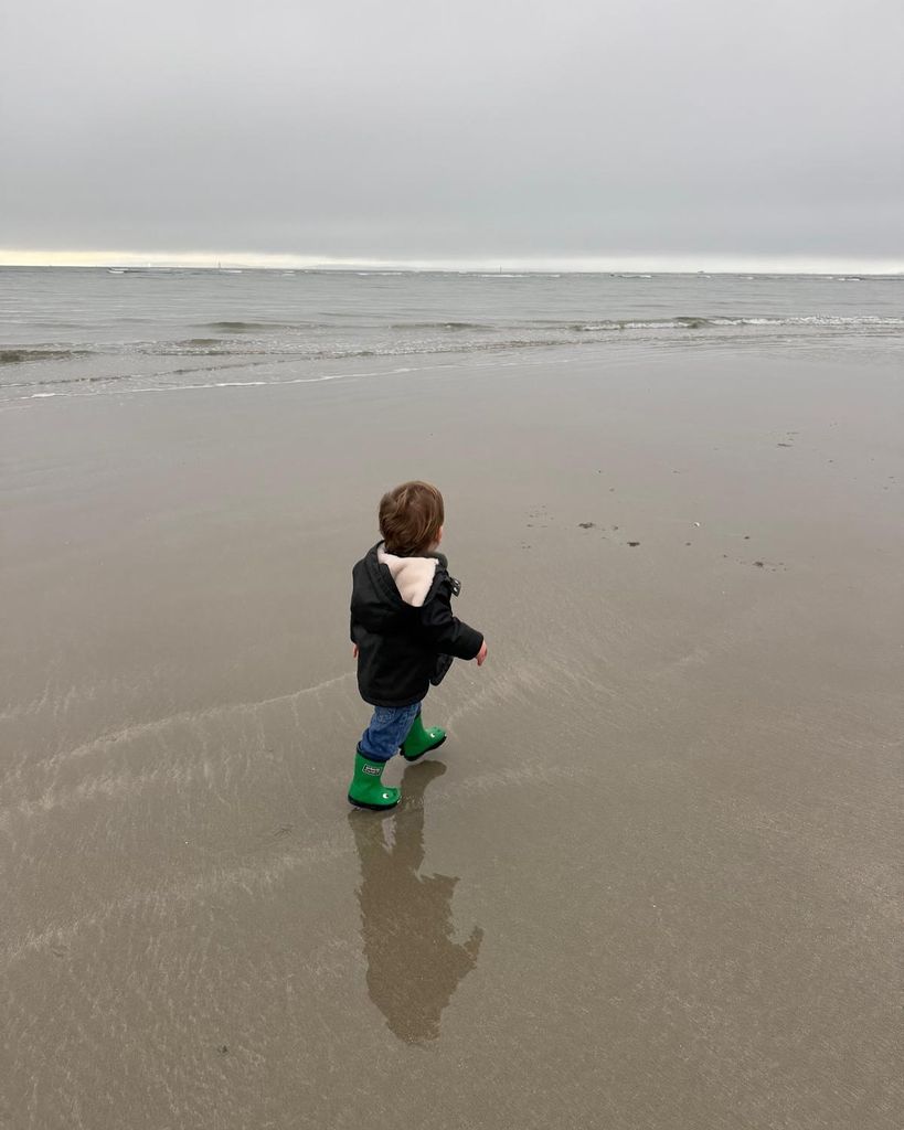 little boy on beach in coat