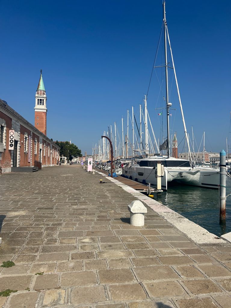 A photo of a line of yachts and a blue sky