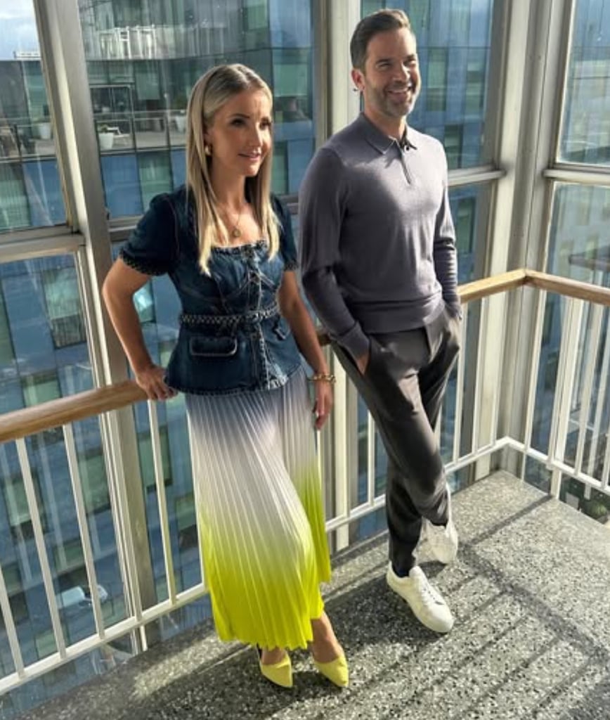 blonde woman and tall man stood on terrace