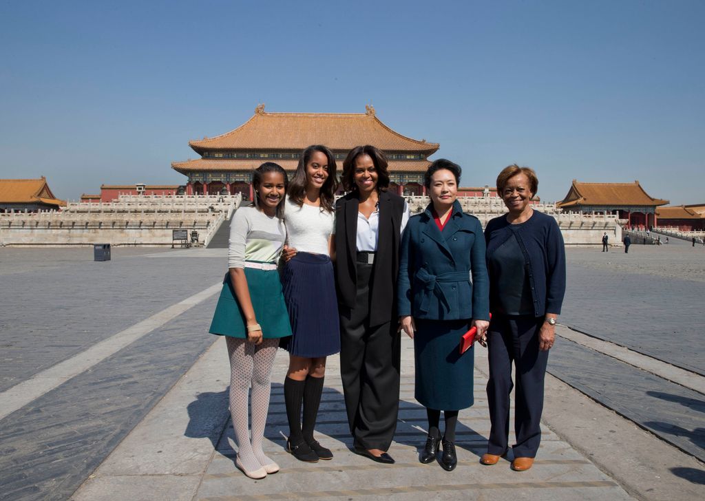 U.S. first lady Michelle Obama, center, her daughters from left Sasha, Malia, Michelle Obama's mother Marian Robinson, right, and Peng Liyuan, wife of Chinese President Xi Jinping pose for photograph as they visit to Forbidden City, March 21, 2014 in Beijing, China. Michelle Obama's one-week-long visit in China will be focused on educational and cultural exchanges.