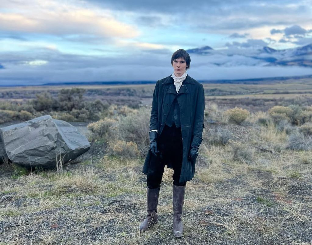 Dylan Brosnan poses for a photo in costume on the set of "The Unholy Trinity" in Montana, shared on Instagram