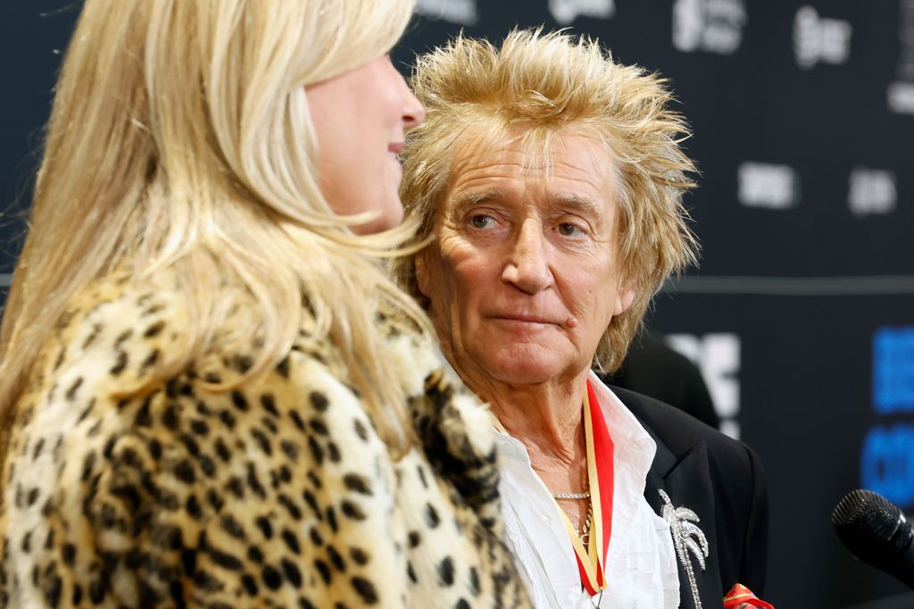 Rod Stewart and Penny Lancaster looking sad 