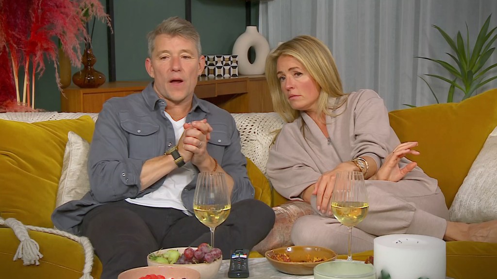Ben Shephard and Cat Deeley sitting on a yellow sofa with snacks in front of them while filming Celebrity Gogglebox