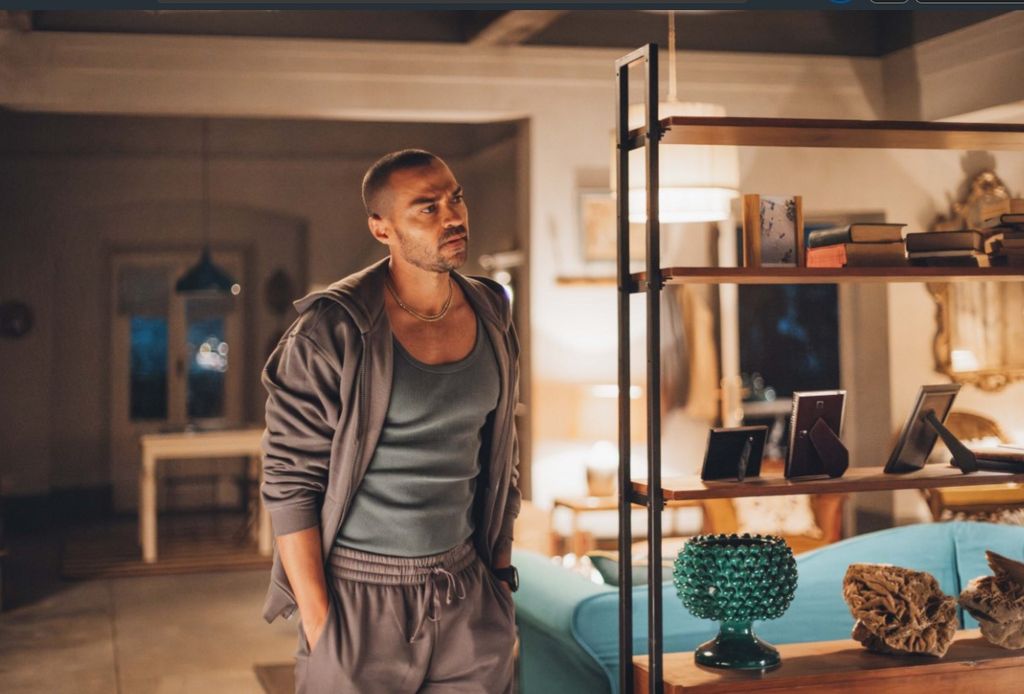 man standing in room wearing sweatshirt and sweatpants
