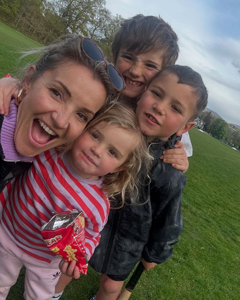 Helen selfie outside with two sons and daughter