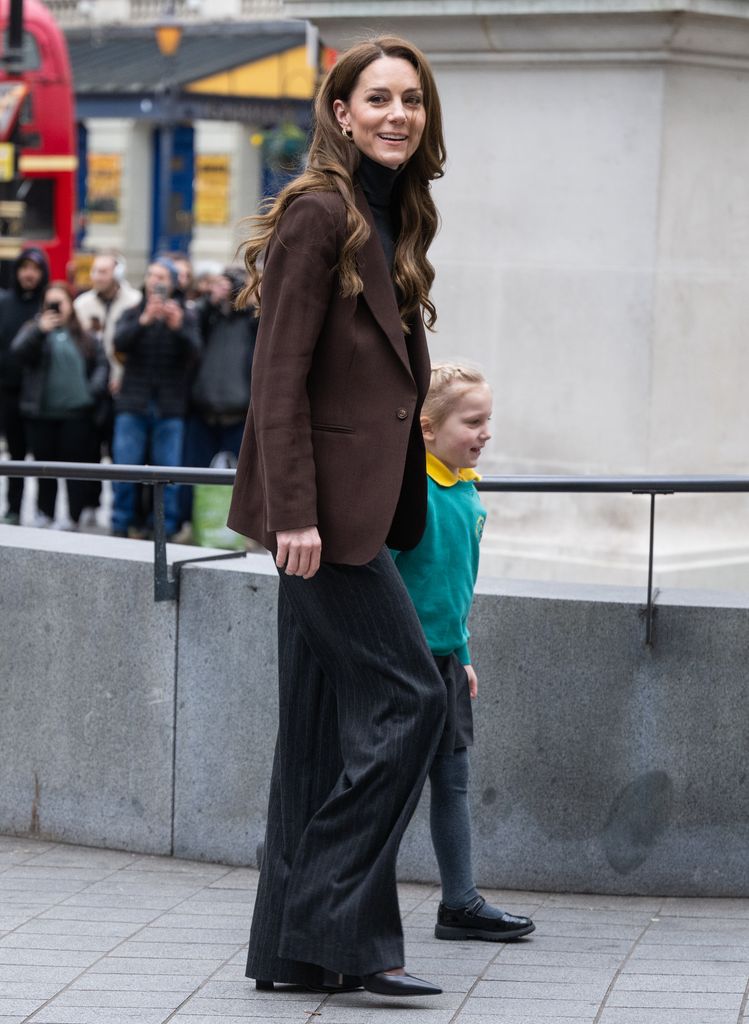 woman wearing trouser suit and brown blazer