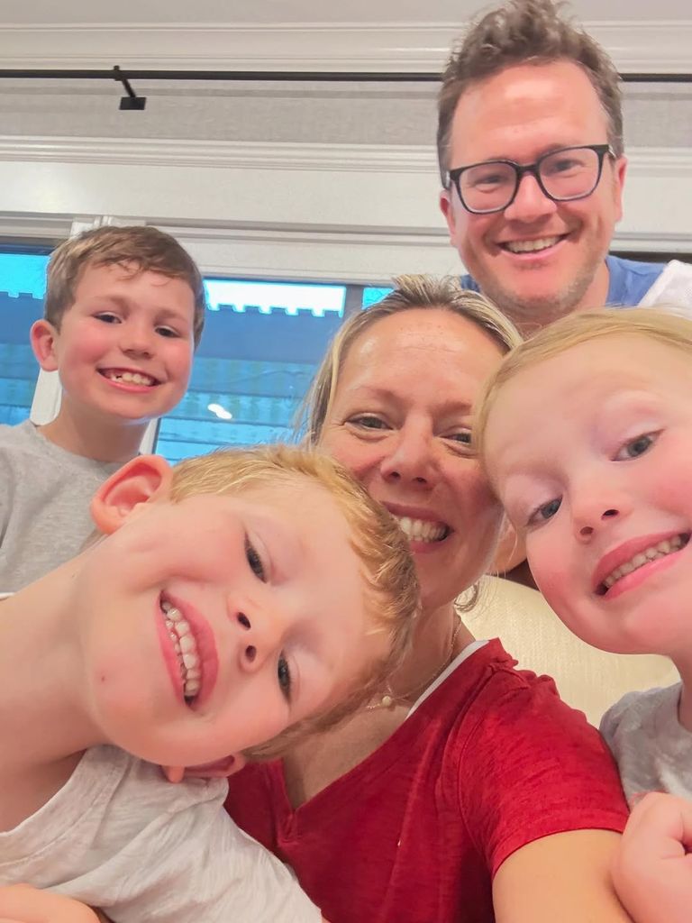 Dylan, Brian and their three kids smiling selfie from home