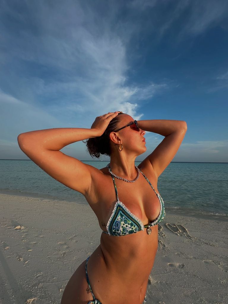 millie bobby brown posing on the beach wearing bikini