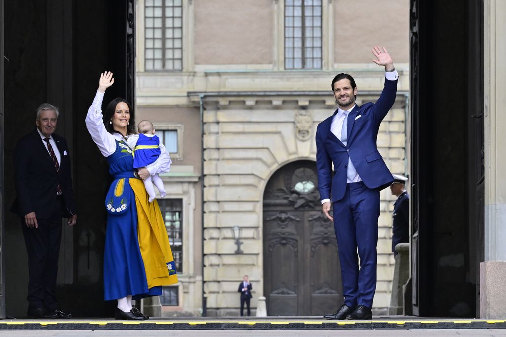 Prince Carl Philip and Princess Sofia wave from palace gates