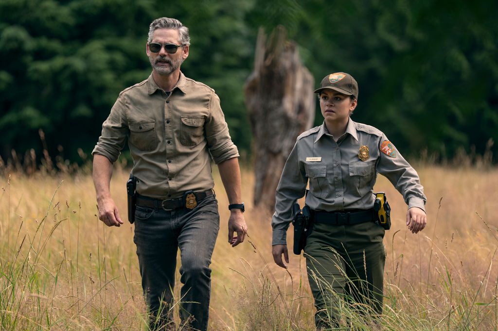 two rangers walking through field