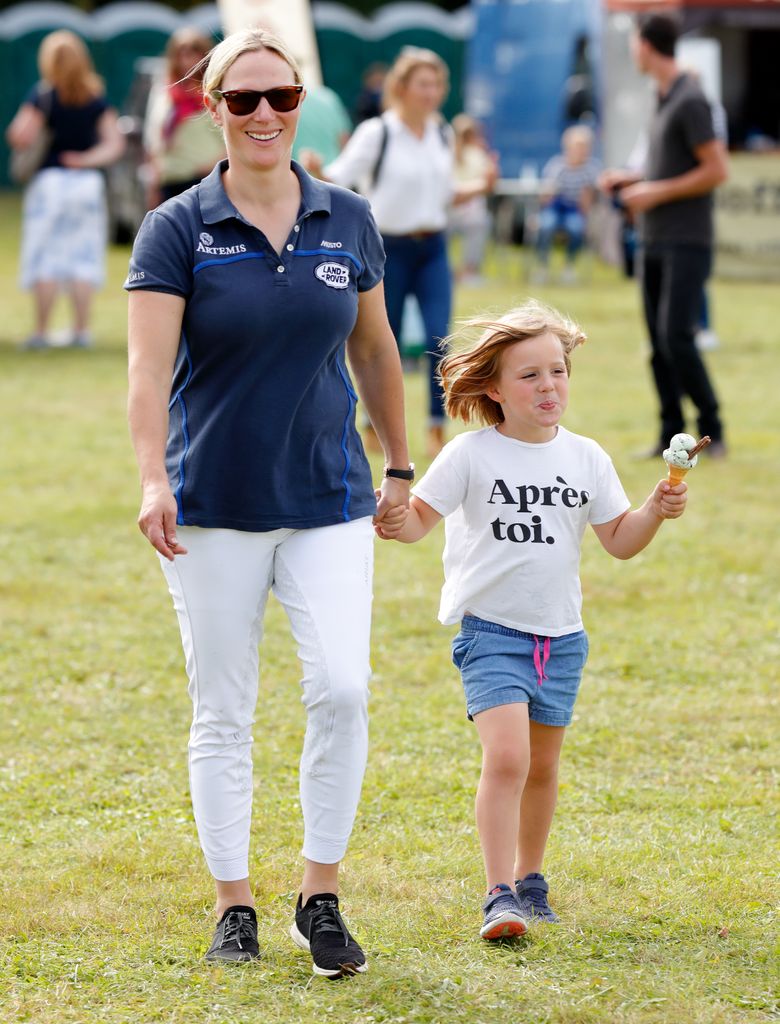 Zara Tindall walks hand in hand with daughter Mia Tindall eating an ice cream