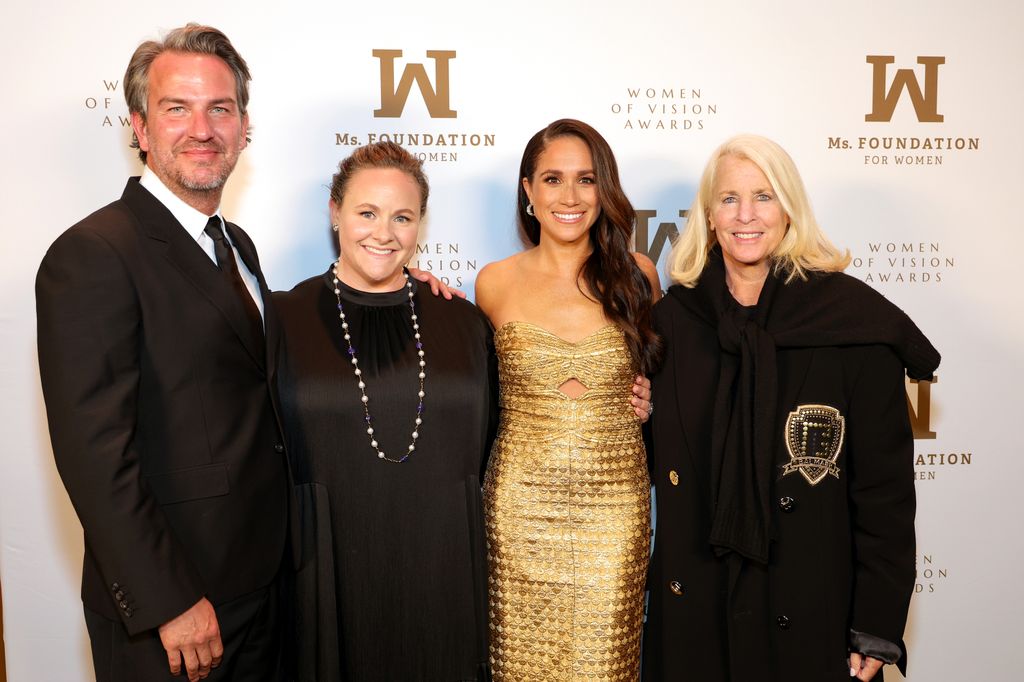 meghan markle alongside two women and a man at awards 