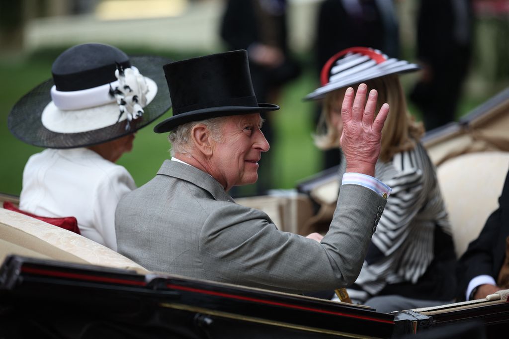 Britain's King Charles III waves as the Royal Procession arrives ahead of racing on the final day of the Royal Ascot horse racing meeting in Ascot, west of London