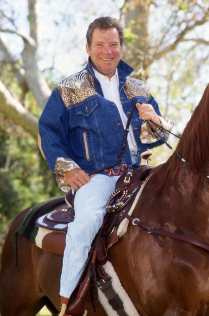 William riding a horse smiling