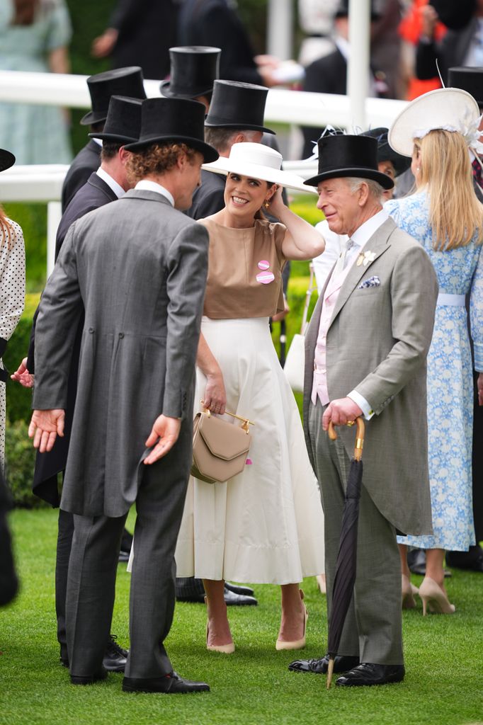 King Charles speaking to Princess Eugenie