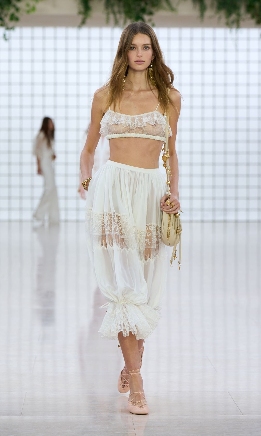 A model wears a pair of bloomers on the Chloé SS25 catwalk during PFW