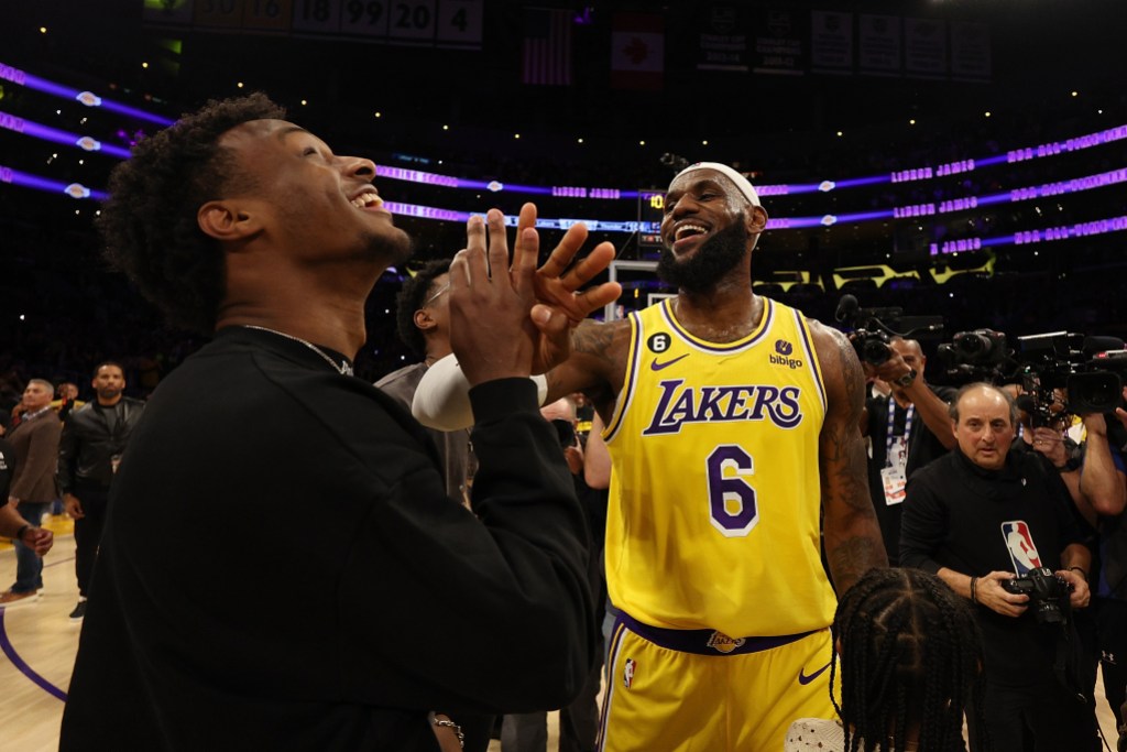 LOS ANGELES, CALIFORNIA - FEBRUARY 07: LeBron James #6 of the Los Angeles Lakers reacts with Bronny James after scoring to pass Kareem Abdul-Jabbar to become the NBA's all-time leading scorer, surpassing Abdul-Jabbar's career total of 38,387 points against the Oklahoma City Thunder at Crypto.com Arena on February 07, 2023 in Los Angeles, California. NOTE TO USER: User expressly acknowledges and agrees that, by downloading and or using this photograph, User is consenting to the terms and conditions of the Getty Images License Agreement. (Photo by Harry How/Getty Images)
