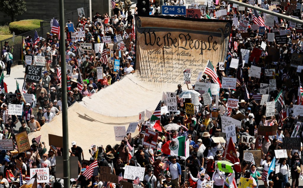 LOS ANGELES, CALIFORNIA - JUNE 14: Protesters carry a banner representing the Preamble to the U.S. Constitution in downtown Los Angeles during an anti-Trump "No Kings Day" demonstration on June 14, 2025 in Los Angeles, California. Hundreds of marches and protests against the Trump administration and its policies are happening across the United States today. Protesters are also reacting in opposition to a planned military parade celebrating the 250th anniversary of the U.S. Army that is taking place in Washington, DC and which coincides with President Trump's birthday.  (Photo by Mario Tama/Getty Images)