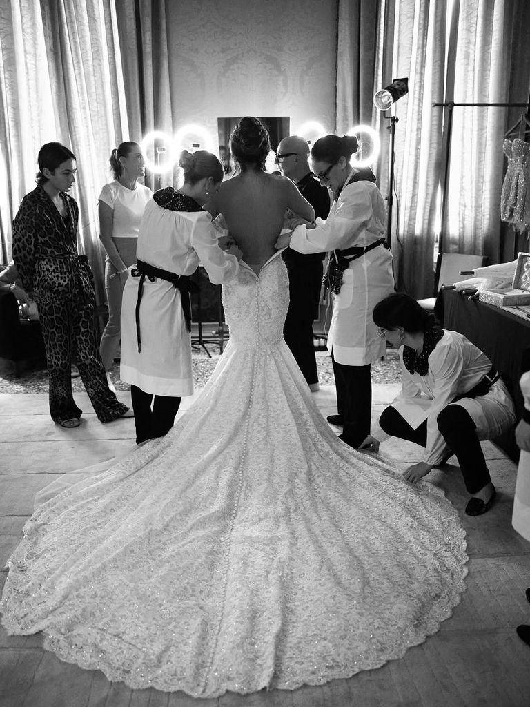 Lauren Sanchez is helped into her dress