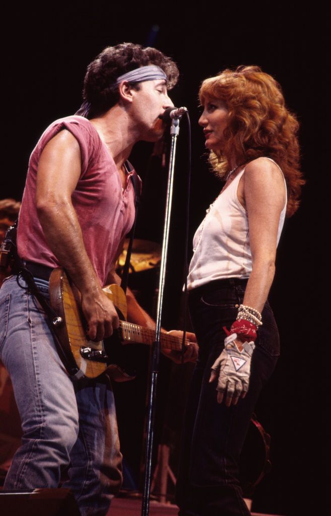 Bruce Springsteen, on guitar, and backing vocalist Patti Scialfa of the E Street Band, perform onstage during the 'Born in the USA' tour in 1985. 