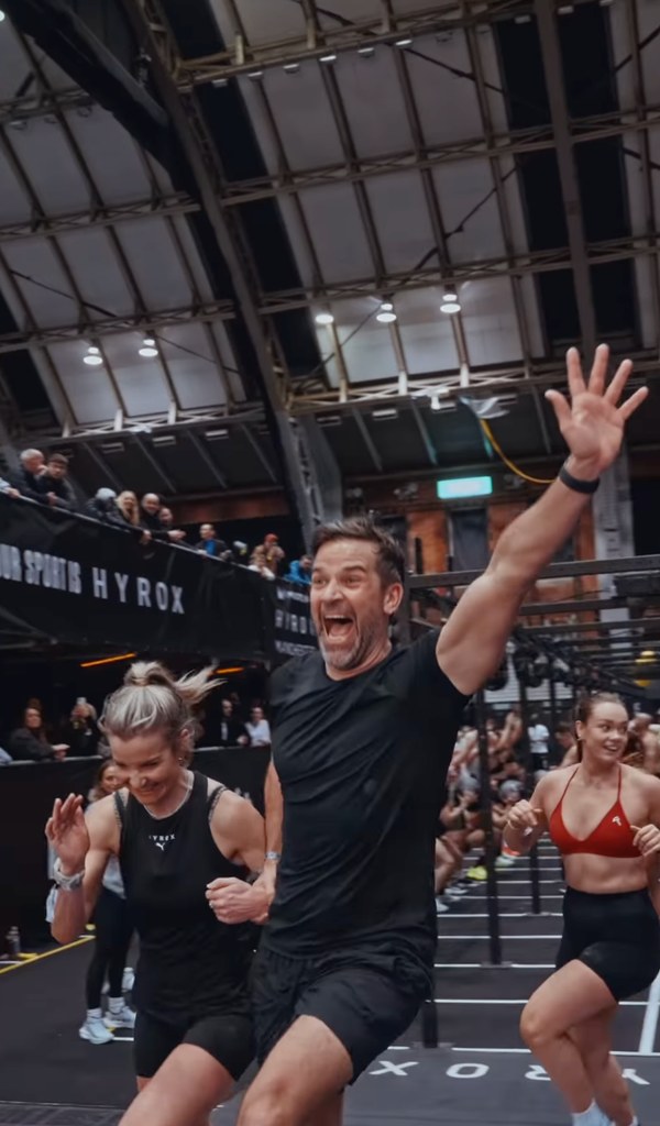 man and woman running looking happy inside arena 