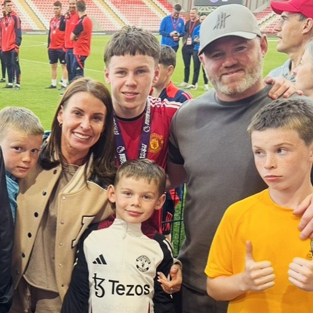 coleen and wayne rooney on pitch with four sons