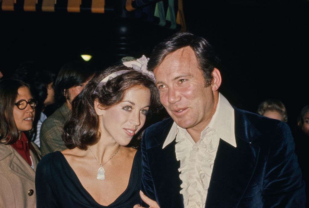 Canadian actor William Shatner, wearing a midnight blue velvet jacket over a white ruffled shirt, open at the collar, and his wife Marcy Lafferty, who wears a black v-neck outfit with a lilac hair bow, attend the 8th Annual American Film Institute Lifetime Achievement Awards, at the Beverly Hilton Hotel in Beverly Hills, California, 28th February 1980.