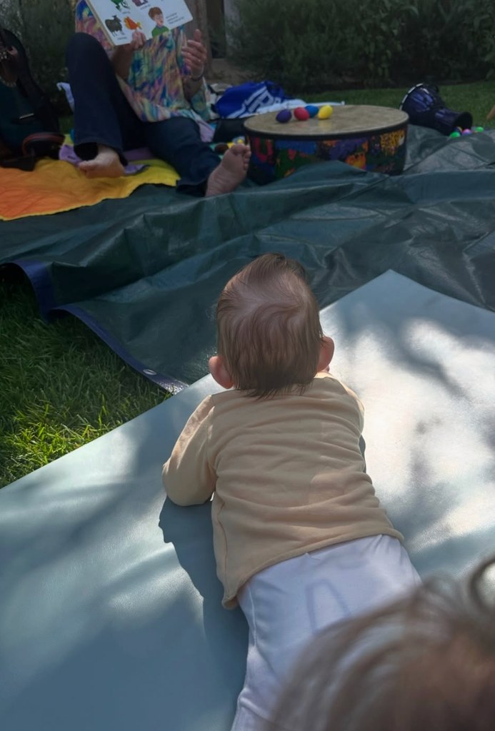 Photo shared by Katherine Schwarzenegger of her baby son Ford laying on his tummy in the grass