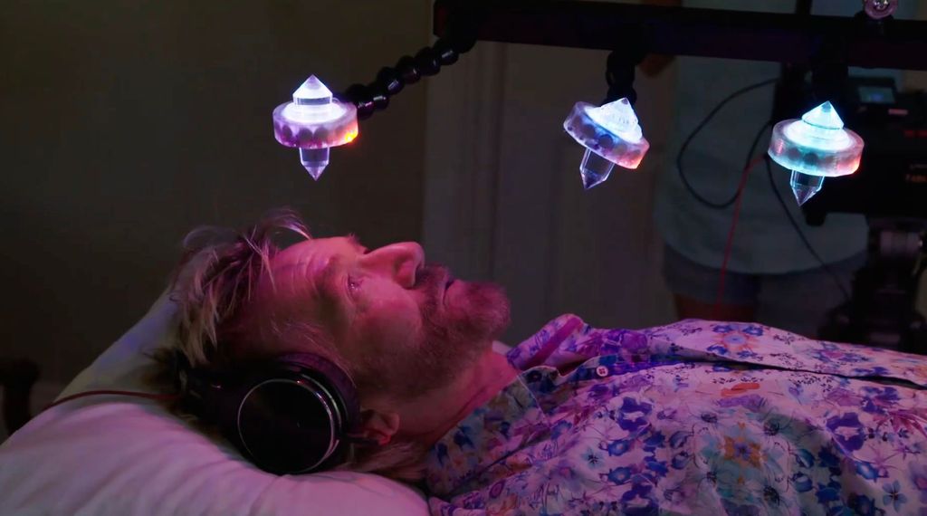 Noel Edmonds meditating under crystals