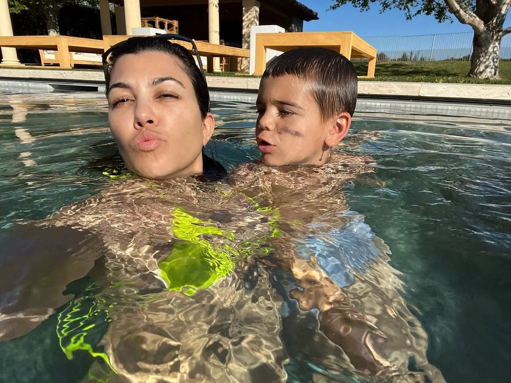 Kourtney Kardashian and her son Reign take selfies while playing in the pool