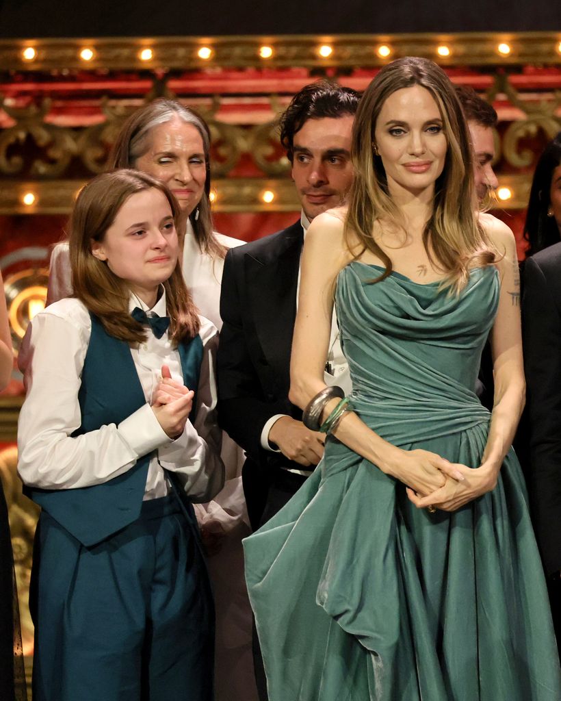 Vivienne Jolie, Angelina Jolie and cast and crew accept the Best Musical award for "The Outsiders" onstage 