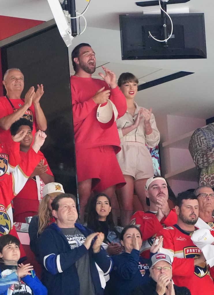 NFL player Travis Kelce and singer Taylor Swift are seen cheering during the first period of Game Four of the 2025 Stanley Cup Final