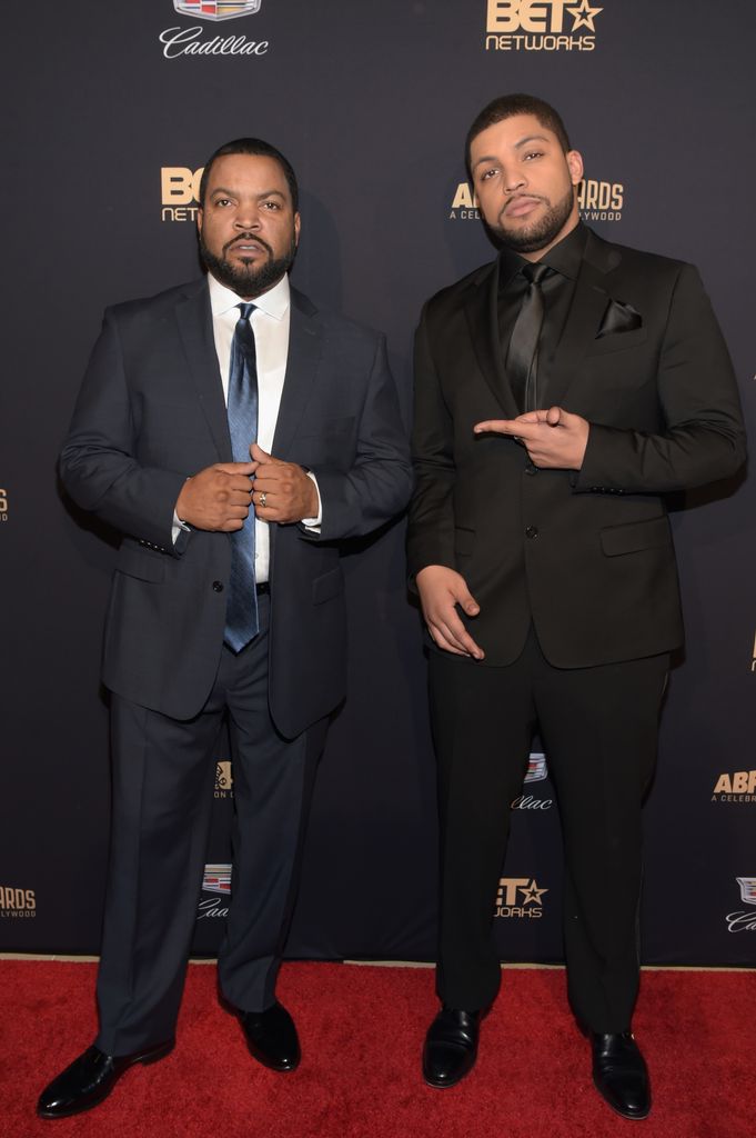Ice Cube and O'Shea Jackson Jr. stood next to each other in suits smiling 