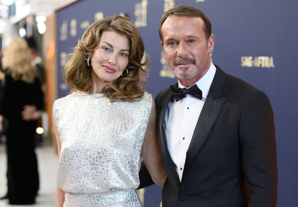 Faith Hill and Tim McGraw hug on the red carpet looking glam