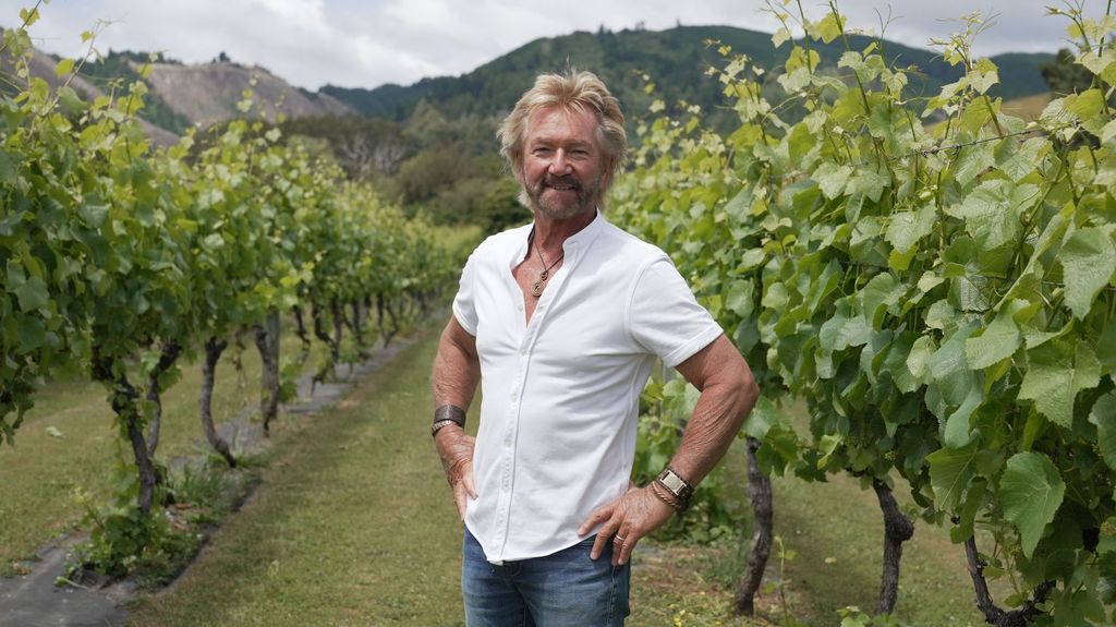 Noel Edmonds' standing in front of vineyard for promo shot of Kiwi Adventure