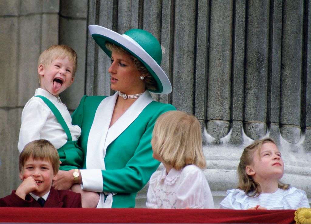 Prince Louis sticking his tongue out and Princess Diana looking at him