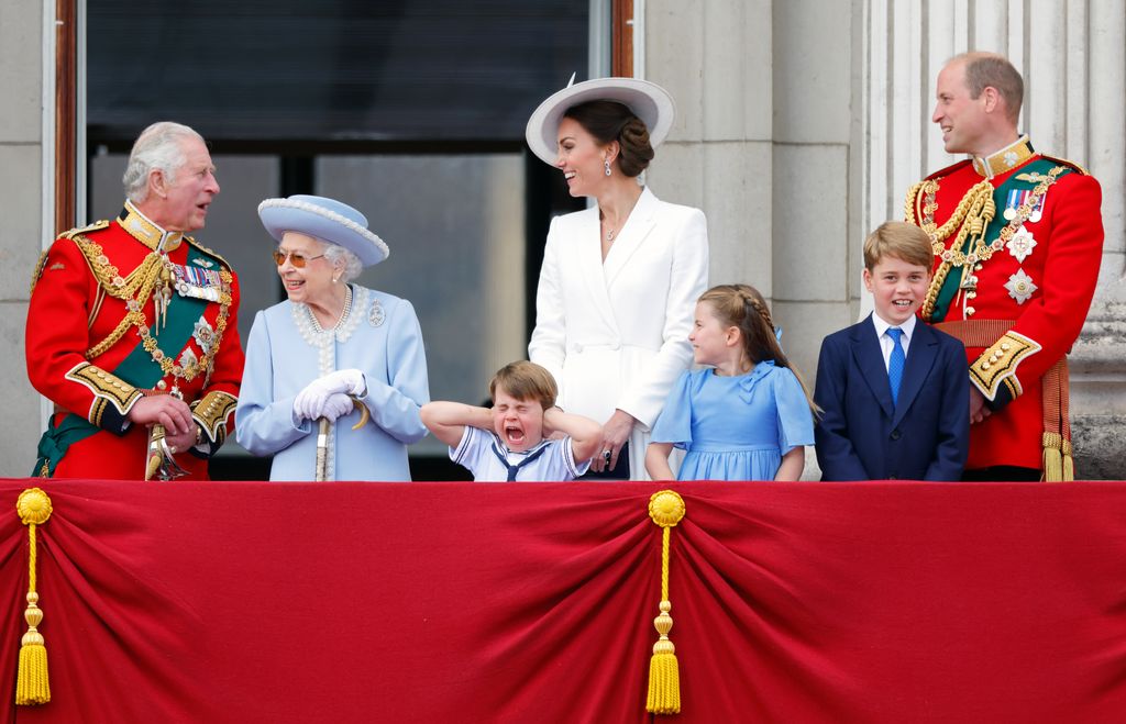 Prince Charles, Prince of Wales, Queen Elizabeth II, Prince Louis of Cambridge, Catherine, Duchess of Cambridge, Princess Charlotte of Cambridge, Prince George of Cambridge and Prince William, Duke of Cambridge watch a flypast from the balcony of Buckingham Palace during Trooping the Colour