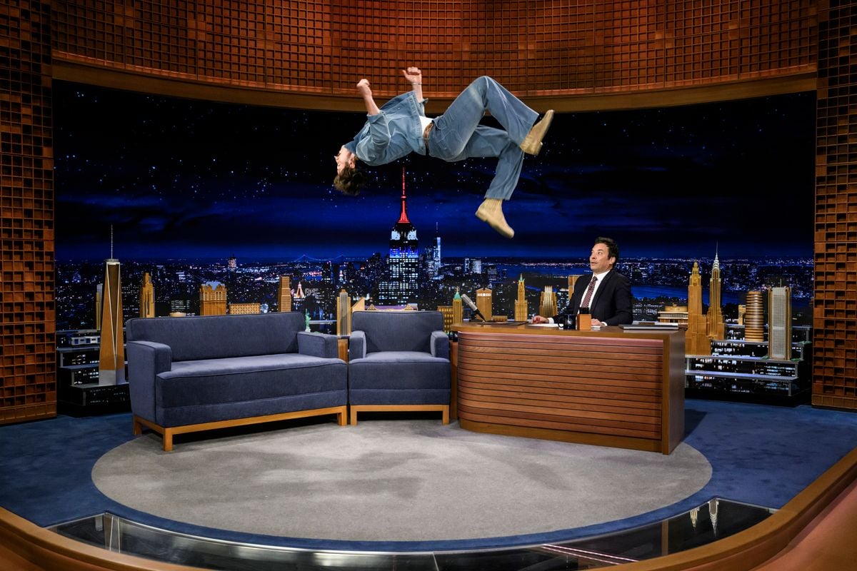 Benson Boone does a back flip during an interview with host Jimmy Fallon 