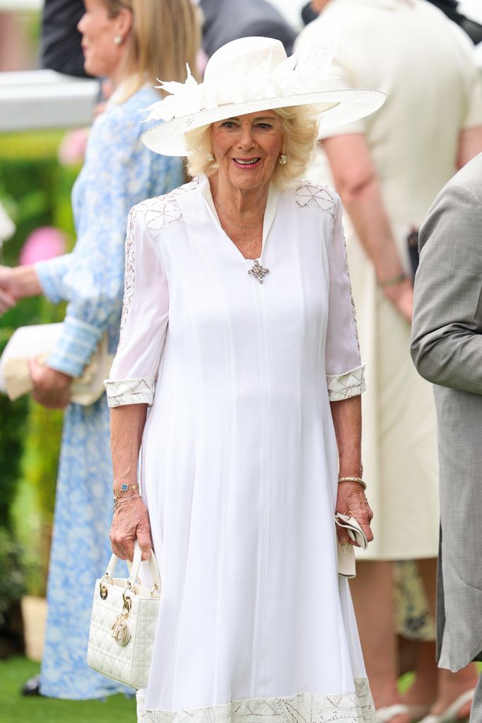 Queen Camilla in white dress and hat