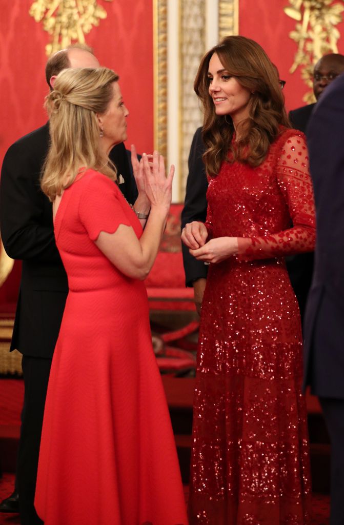 Kate and Sophie wearing red dresses at Buckingham Palace in 2020