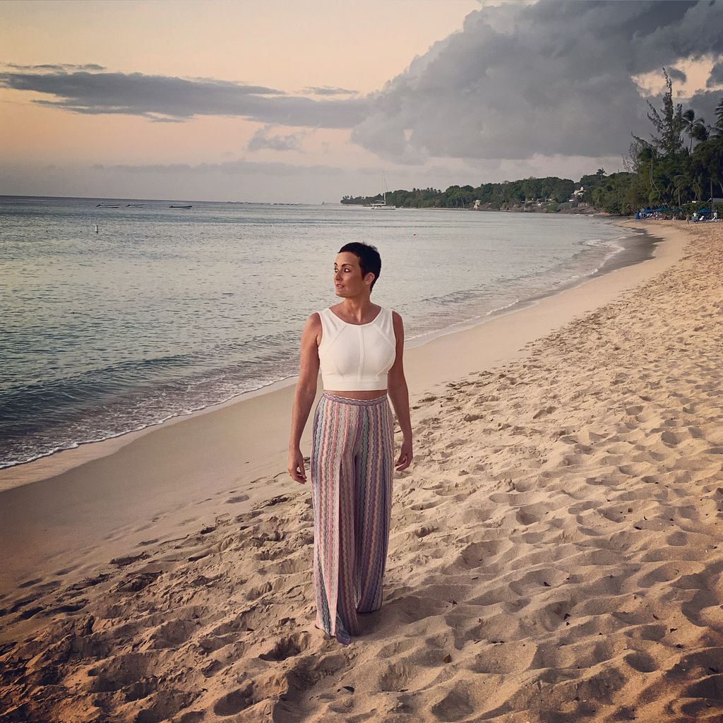 women with short hair standing on a beach