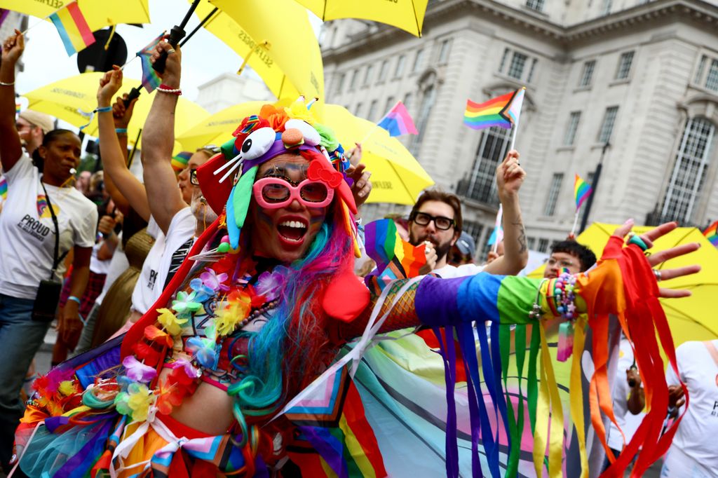 People in colourful costumes celebrating Pride in London