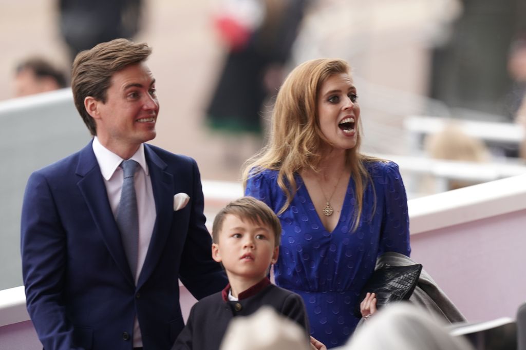 Princess Beatrice in a blue dress smiling with Edoardo and Wolfie